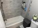Shower area with gray tiled walls, brushed nickel hardware, and built-in shampoo niche at 3316 Cutty Sark St, Las Vegas, NV 89117