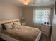 Comfortable bedroom with light walls, wood floor, natural light from window and soft, cushioned, neutral decor at 3316 Cutty Sark St, Las Vegas, NV 89117