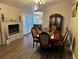 Inviting dining room area featuring fireplace, wood flooring and views into kitchen at 3316 Cutty Sark St, Las Vegas, NV 89117