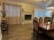 Open-concept dining room features fireplace, natural light, and wood flooring at 3316 Cutty Sark St, Las Vegas, NV 89117