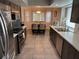 Updated kitchen features dark wood cabinetry, stainless appliances, and an island with bar seating at 3316 Cutty Sark St, Las Vegas, NV 89117