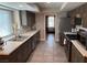 Recently remodeled kitchen with stainless appliances, dark wood cabinetry, and tile flooring at 3316 Cutty Sark St, Las Vegas, NV 89117
