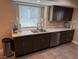 Updated kitchen with stainless appliances, dark wood cabinets and modern fixtures at 3316 Cutty Sark St, Las Vegas, NV 89117