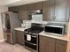 Updated kitchen features stainless steel appliances, dark cabinets, and light countertops at 3316 Cutty Sark St, Las Vegas, NV 89117