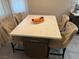 A bright kitchen island features a marble countertop and cabinetry, complemented by comfortable seating with nailhead trim at 3316 Cutty Sark St, Las Vegas, NV 89117