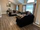 Spacious living room featuring hardwood floors, upscale decor, and lots of natural light from large windows at 3316 Cutty Sark St, Las Vegas, NV 89117