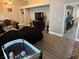 Open-concept living area with a modern kitchen, sleek dark wood floors, and comfortable seating at 3316 Cutty Sark St, Las Vegas, NV 89117