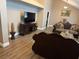 Inviting living room with hardwood floors, high ceilings, a large TV, and cozy, sophisticated decor at 3316 Cutty Sark St, Las Vegas, NV 89117