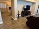 Spacious living room featuring hardwood floors, modern entertainment center, and cozy seating areas at 3316 Cutty Sark St, Las Vegas, NV 89117