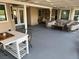 Covered patio with neutral decor, dining area, egg chair, and comfortable outdoor seating at 3316 Cutty Sark St, Las Vegas, NV 89117