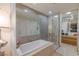 Bright bathroom features a soaking tub, walk-in shower, and ample storage in the contemporary vanity and cabinets at 3722 Las Vegas Blvd # 2904, Las Vegas, NV 89158