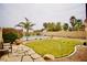 A beautiful backyard features a lush lawn, a charming stone pathway, and a refreshing pool at 3916 Broad Meadow Ct, Las Vegas, NV 89129