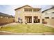 Lush backyard featuring a manicured lawn and a covered patio for outdoor dining and entertainment at 3916 Broad Meadow Ct, Las Vegas, NV 89129