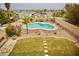 Aerial view of a private backyard featuring a custom-shaped pool, desert landscaping, and privacy walls at 3916 Broad Meadow Ct, Las Vegas, NV 89129