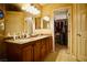 Bathroom features a dual sink vanity, closet, and tile flooring at 3916 Broad Meadow Ct, Las Vegas, NV 89129