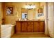 Bathroom featuring a dual vanity, bathtub, and tasteful decorations at 3916 Broad Meadow Ct, Las Vegas, NV 89129