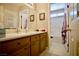 Well-lit bathroom featuring a vanity with drawers and a mirror and adjacent toilet and bathtub area at 3916 Broad Meadow Ct, Las Vegas, NV 89129