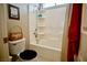 Bathroom with a bathtub and shower combination featuring white subway tile and a built-in shelving unit at 3916 Broad Meadow Ct, Las Vegas, NV 89129