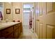 Bathroom with a wide mirror, dark cabinets and a white sink at 3916 Broad Meadow Ct, Las Vegas, NV 89129