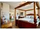 Well-lit bedroom with a four-poster bed, neutral walls, and ensuite entrance at 3916 Broad Meadow Ct, Las Vegas, NV 89129