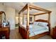 Comfortable bedroom with a four-poster bed and ample natural light at 3916 Broad Meadow Ct, Las Vegas, NV 89129