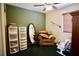 Cozy room with plush green carpeting with olive green and white paneled walls and ceiling fan at 3916 Broad Meadow Ct, Las Vegas, NV 89129