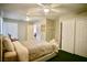 Bedroom suite with ceiling fans, a bed, and sliding door closet at 3916 Broad Meadow Ct, Las Vegas, NV 89129