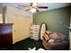 Bedroom with olive-green paneled walls and a closet and ceiling fan with a light at 3916 Broad Meadow Ct, Las Vegas, NV 89129