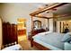 Spacious bedroom boasts a beautiful four-poster bed and adjoining ensuite bathroom at 3916 Broad Meadow Ct, Las Vegas, NV 89129