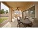 Relaxing covered patio with ceiling fan and outdoor seating area, perfect for enjoying the backyard view at 3916 Broad Meadow Ct, Las Vegas, NV 89129
