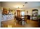 Open dining room with wood floors and decorative chandelier adjacent to the kitchen at 3916 Broad Meadow Ct, Las Vegas, NV 89129
