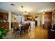 Open dining room with wood floors and decorative chandelier adjacent to the kitchen at 3916 Broad Meadow Ct, Las Vegas, NV 89129