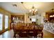 Inviting dining room with wood floors, glass door to patio, and elegant chandelier at 3916 Broad Meadow Ct, Las Vegas, NV 89129