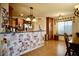 Open floorplan includes a dining room with wood floors and wooden cabinets in the kitchen at 3916 Broad Meadow Ct, Las Vegas, NV 89129