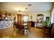 Open dining room with wood floors and decorative chandelier adjacent to the kitchen at 3916 Broad Meadow Ct, Las Vegas, NV 89129