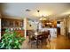 Open dining room with wood floors and decorative chandelier adjacent to the kitchen at 3916 Broad Meadow Ct, Las Vegas, NV 89129