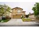 Two-story home featuring a two-car garage, arched windows and manicured lawn at 3916 Broad Meadow Ct, Las Vegas, NV 89129