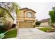 Two-story home featuring a two-car garage, arched windows and manicured lawn at 3916 Broad Meadow Ct, Las Vegas, NV 89129