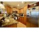 Functional kitchen featuring stainless steel appliances, wooden cabinets, and granite countertops at 3916 Broad Meadow Ct, Las Vegas, NV 89129
