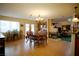 Open living space with wood flooring, a fireplace, dining area, and kitchen at 3916 Broad Meadow Ct, Las Vegas, NV 89129