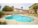 Sparkling swimming pool with a baja step is surrounded by lush landscaping and a private backyard at 3916 Broad Meadow Ct, Las Vegas, NV 89129
