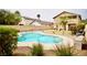 Inviting kidney-shaped pool is surrounded by a patio and lush landscaping, perfect for outdoor relaxation at 3916 Broad Meadow Ct, Las Vegas, NV 89129