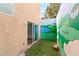 Backyard space features a faux putting green, creating a unique and fun outdoor recreational area with mural at 4195 Balmoral Castle Ct, Las Vegas, NV 89141