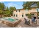 Spacious backyard featuring a pool, spa, outdoor seating, built-in grill, and mature landscaping at 4195 Balmoral Castle Ct, Las Vegas, NV 89141