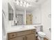 Bright bathroom featuring a large mirror, modern vanity, and walk-in shower with tiled surround at 4195 Balmoral Castle Ct, Las Vegas, NV 89141