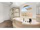 Bright bathroom with a large soaking tub and a glass-enclosed shower at 4195 Balmoral Castle Ct, Las Vegas, NV 89141