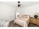 Comfortable bedroom boasts a well-made bed, classic dresser, and light from the hall, exuding a cozy atmosphere at 4195 Balmoral Castle Ct, Las Vegas, NV 89141