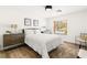 Inviting bedroom with a cozy bed, wood floors, a window providing natural light, and side tables with lamps at 4195 Balmoral Castle Ct, Las Vegas, NV 89141