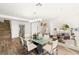 Spacious dining area with a glass table, decorative lighting, and views into the living room at 4195 Balmoral Castle Ct, Las Vegas, NV 89141