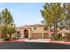 Elegant two-story home featuring an arched entry, three-car garage and manicured landscaping at 4195 Balmoral Castle Ct, Las Vegas, NV 89141